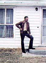 John Olberding at the stoop of his less-than-$1,000 home.